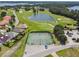Aerial shot of tennis courts in Deer Island Golf community surrounded by a lush green golf course and waterfront homes at 30215 Island Club Dr, Deer Island, FL 32778