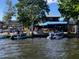 Boats parked on a lake near a restaurant with outdoor seating under an awning, for lakeside entertainment at 30215 Island Club Dr, Deer Island, FL 32778