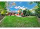 Expansive backyard featuring lush lawn, mature trees, and patio area with seating and grill at 3518 Edlingham Ct, Belle Isle, FL 32812