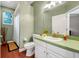 Relaxing bathroom featuring green walls and a functional single sink vanity at 3518 Edlingham Ct, Belle Isle, FL 32812