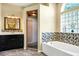 Elegant bathroom featuring dual vanities, a separate shower, and a luxurious soaking tub for ultimate relaxation at 3518 Edlingham Ct, Belle Isle, FL 32812