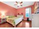Comfortable bedroom with colorful accents, hardwood floors, and natural light at 3518 Edlingham Ct, Belle Isle, FL 32812