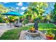Outdoor firepit and water feature with lounge chairs, perfect for relaxing in this home's backyard at 3518 Edlingham Ct, Belle Isle, FL 32812