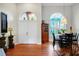 Inviting foyer with arched windows, hardwood floors, and stylish decor, providing a warm welcome to the home at 3518 Edlingham Ct, Belle Isle, FL 32812