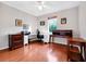 Spacious home office with hardwood floors, large desk, and natural light at 3518 Edlingham Ct, Belle Isle, FL 32812