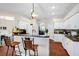 Open kitchen with breakfast bar, white cabinets, and view of the adjacent living area at 3518 Edlingham Ct, Belle Isle, FL 32812
