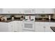 Clean white kitchen featuring modern appliances, stylish backsplash, and ample counter space at 3518 Edlingham Ct, Belle Isle, FL 32812