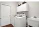 Functional laundry room with washer, dryer, sink and convenient overhead cabinets at 3518 Edlingham Ct, Belle Isle, FL 32812