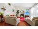 Spacious living room with a fireplace, vaulted ceilings, and stylish decor, creating a bright and inviting ambiance at 3518 Edlingham Ct, Belle Isle, FL 32812