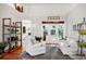 Bright living room with white furniture, hardwood floors, and view to the outdoor patio at 3518 Edlingham Ct, Belle Isle, FL 32812