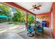 Inviting covered patio with dining table, grill, and lush green backyard with seating area at 3518 Edlingham Ct, Belle Isle, FL 32812