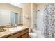 Bright bathroom featuring a shower/tub combo and granite countertops with a white sink at 3632 Solana Cir # B, Clermont, FL 34711