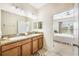 Spacious bathroom featuring dual sinks and ample countertop space with bedroom access at 3632 Solana Cir # B, Clermont, FL 34711