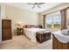 Bright bedroom with a ceiling fan and large window offering scenic views at 3632 Solana Cir # B, Clermont, FL 34711