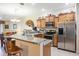 Modern kitchen with stainless steel appliances and a granite countertop breakfast bar at 3632 Solana Cir # B, Clermont, FL 34711