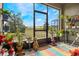 A screened lanai filled with plants overlooks a sprawling green yard with distant trees at 3632 Solana Cir # B, Clermont, FL 34711