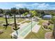 Aerial view of community shuffleboard and bocce ball facilities, with mature landscaping at 3632 Solana Cir # B, Clermont, FL 34711