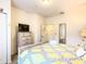 Comfortable bedroom featuring a queen-size bed, dresser with TV, and a closet at 5352 Diplomat Ct # 107, Kissimmee, FL 34746