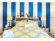 Bright bedroom with a queen-size bed and a custom striped accent wall at 5352 Diplomat Ct # 107, Kissimmee, FL 34746