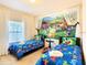 Inviting bedroom featuring twin beds and colorful décor at 5352 Diplomat Ct # 107, Kissimmee, FL 34746