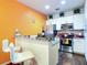 Modern kitchen with stainless steel appliances, breakfast bar and white cabinetry at 5352 Diplomat Ct # 107, Kissimmee, FL 34746