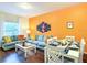 Cozy living room and dining area, with comfortable seating and bright accent wall at 5352 Diplomat Ct # 107, Kissimmee, FL 34746