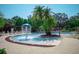 Community pool with a water fountain and palm trees at 5352 Diplomat Ct # 107, Kissimmee, FL 34746