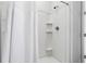 Bathroom shower with white tile, built-in shelves and a shower curtain at 580 Buchannan Dr, Davenport, FL 33837