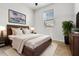 Comfortable bedroom features a bed with a soft rug, a window, and modern decor at 580 Buchannan Dr, Davenport, FL 33837
