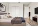Bedroom features a comfortable bed with a throw blanket, neutral decor, and closet space at 580 Buchannan Dr, Davenport, FL 33837