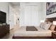 Inviting bedroom with wooden flooring, a comfortable bed, neutral decor, and closet space at 580 Buchannan Dr, Davenport, FL 33837