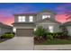 Charming two-story home features a well-maintained yard, neutral exterior paint and attached two car garage at 580 Buchannan Dr, Davenport, FL 33837