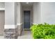 Welcoming front door, flanked by stone accents and lush greenery, inviting you into your dream home at 580 Buchannan Dr, Davenport, FL 33837