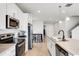 Modern kitchen offers stainless appliances, ample counter space and an island with seating in an open layout at 580 Buchannan Dr, Davenport, FL 33837