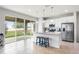 Modern kitchen with stainless appliances, large island with bar seating and a view of the spacious backyard at 580 Buchannan Dr, Davenport, FL 33837