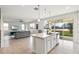 Modern kitchen flows into the living space with bright light, stainless appliances, island and patio access at 580 Buchannan Dr, Davenport, FL 33837