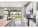 Modern kitchen offers sleek stainless steel appliances, ample counter space, and an island with pendant lighting at 580 Buchannan Dr, Davenport, FL 33837