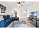 Open-concept living area featuring comfortable seating, a modern TV, and sleek, neutral decor at 580 Buchannan Dr, Davenport, FL 33837