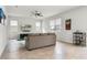 Bright living room with a ceiling fan, entertainment center, and an adjacent bar cart at 580 Buchannan Dr, Davenport, FL 33837