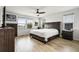 Cozy main bedroom featuring wood floors, neutral walls, ceiling fan and ample natural light at 580 Buchannan Dr, Davenport, FL 33837