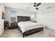 Comfortable main bedroom with wood-look floors, ceiling fan, and large windows at 580 Buchannan Dr, Davenport, FL 33837