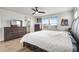 Spacious main bedroom with wood-look floors, ceiling fan, and ample closet space, plus a peek at the bathroom at 580 Buchannan Dr, Davenport, FL 33837