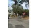 Community entrance with gated access and stop signs to ensure traffic safety and resident privacy at 6100 Westgate Dr # 203, Orlando, FL 32835
