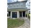 Exterior view of condo building with attached storage units and covered entries at 6100 Westgate Dr # 203, Orlando, FL 32835
