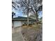 Charming home featuring an attached garage, a durable green roof, and mature landscaping at 6100 Westgate Dr # 203, Orlando, FL 32835