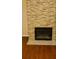 Modern fireplace with stone facade and dark wood floors, a cozy feature for any home at 6100 Westgate Dr # 203, Orlando, FL 32835