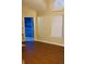 Living room with balcony access, wood floor, and big window at 6100 Westgate Dr # 203, Orlando, FL 32835