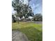 Scenic view of green lawn and trees lining a street in a quiet neighborhood at 6100 Westgate Dr # 203, Orlando, FL 32835