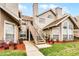 Condo exterior featuring tan siding, a stairway to upper units, and well-manicured landscaping at 625 Greencove Ter # 130, Altamonte Springs, FL 32714