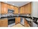 Modern kitchen featuring stainless steel appliances, granite countertops, and mosaic backsplash at 625 Greencove Ter # 130, Altamonte Springs, FL 32714